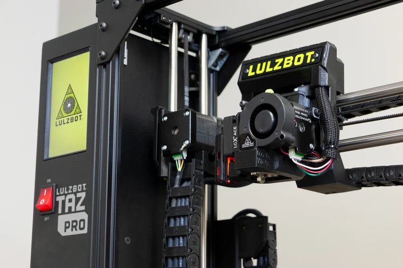 LulzBot TAZ Pro 3D printer with a focus on the Lulzbot Meteor 285 Tool Head attached to the printer.